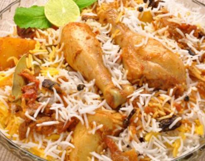 A plate of fragrant dum biryani garnished with fried onions