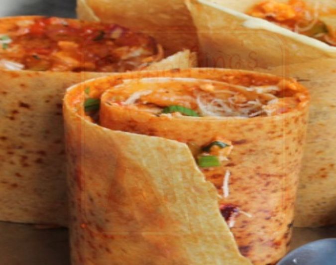 A spread of rich Indian curries served with naan
